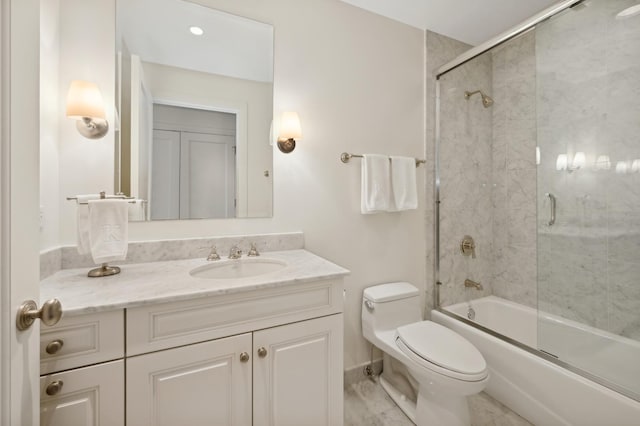 full bathroom featuring toilet, vanity, and shower / bath combination with glass door