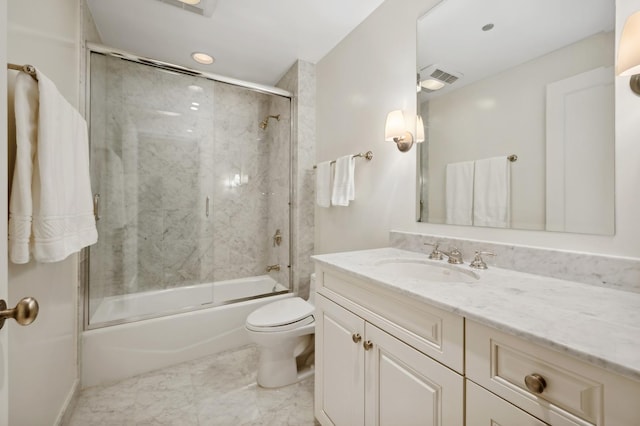 full bathroom with bath / shower combo with glass door, vanity, and toilet