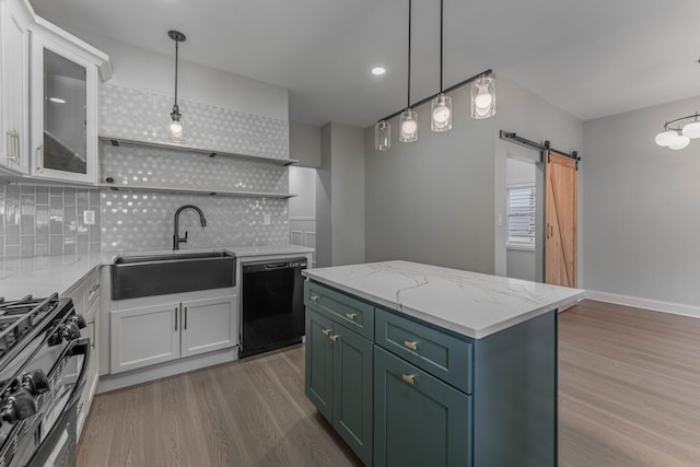 kitchen featuring white cabinetry, a barn door, and dishwasher