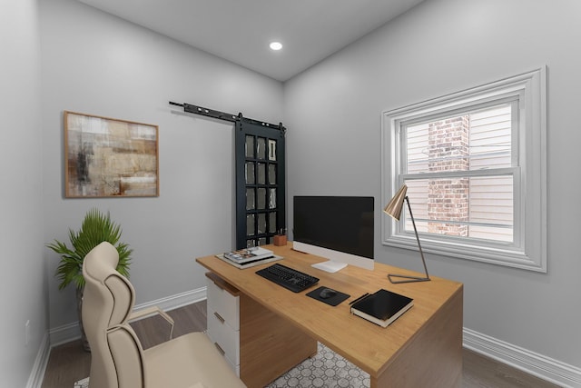 office space with dark hardwood / wood-style flooring and a barn door