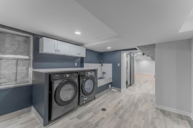 laundry room featuring light hardwood / wood-style flooring and washer and clothes dryer