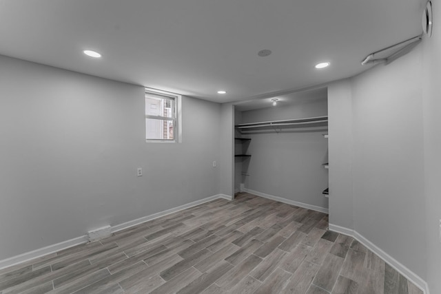 basement with light hardwood / wood-style flooring