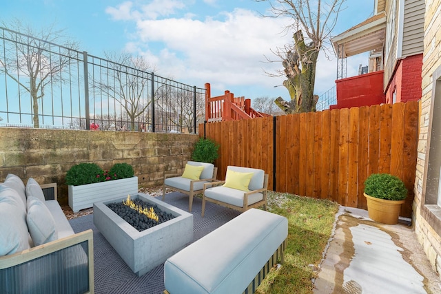 view of patio / terrace with an outdoor living space with a fire pit