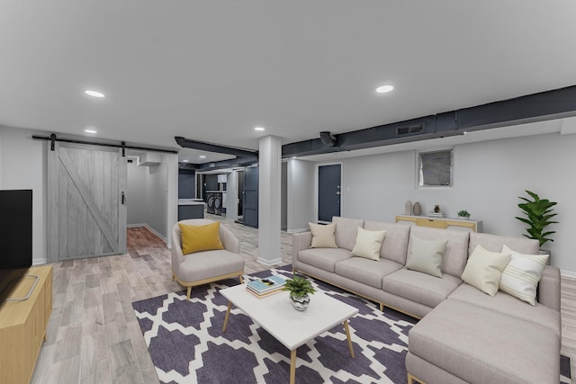 living room with light hardwood / wood-style floors and a barn door