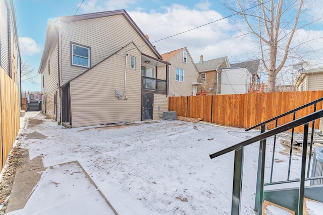 view of snow covered rear of property