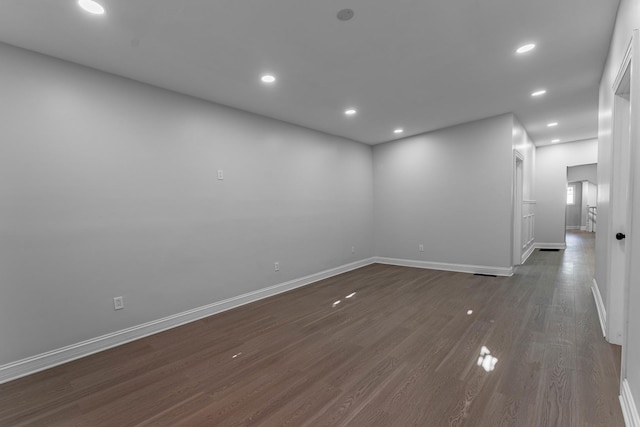 spare room with dark wood-type flooring