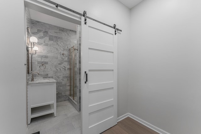 bathroom featuring vanity, hardwood / wood-style flooring, and a shower with shower door