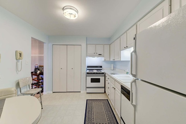 kitchen with sink, white cabinets, and white appliances