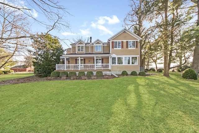 view of front of property with a front yard and covered porch