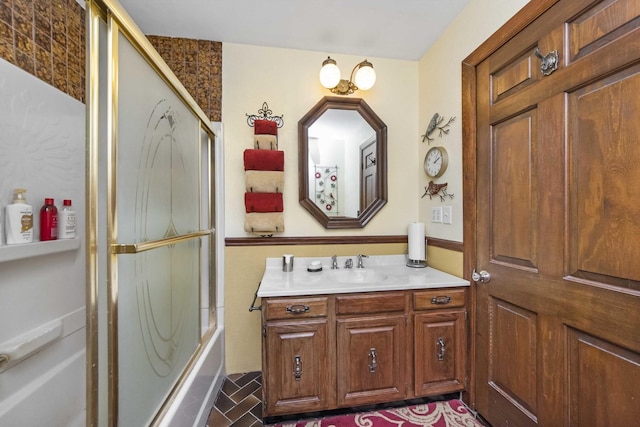 bathroom with vanity and combined bath / shower with glass door