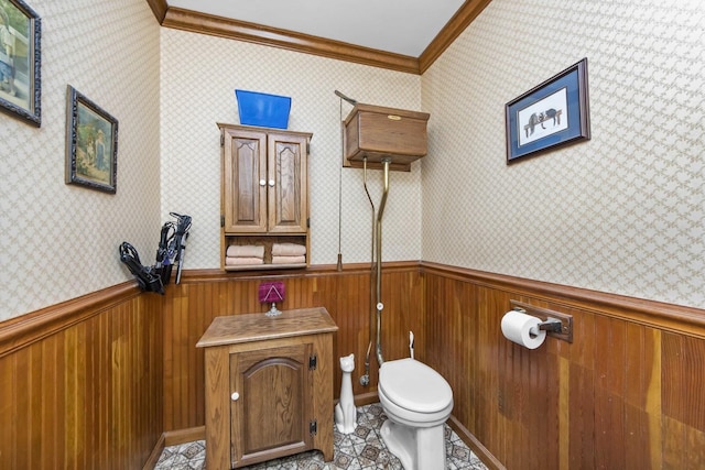 bathroom featuring tile patterned floors, ornamental molding, and toilet