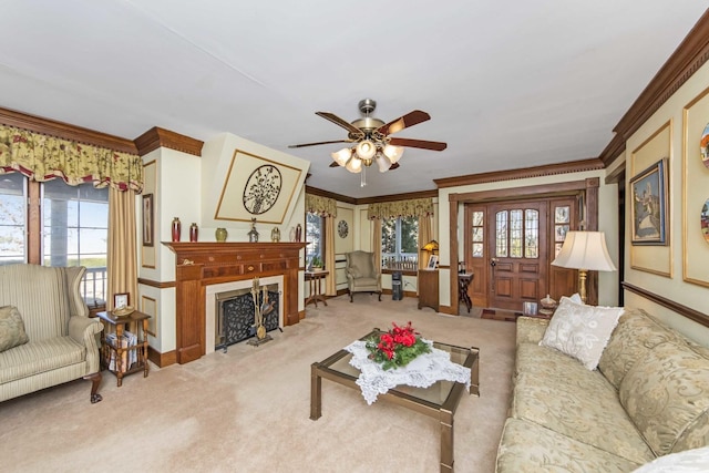 carpeted living room featuring crown molding, ceiling fan, and a healthy amount of sunlight