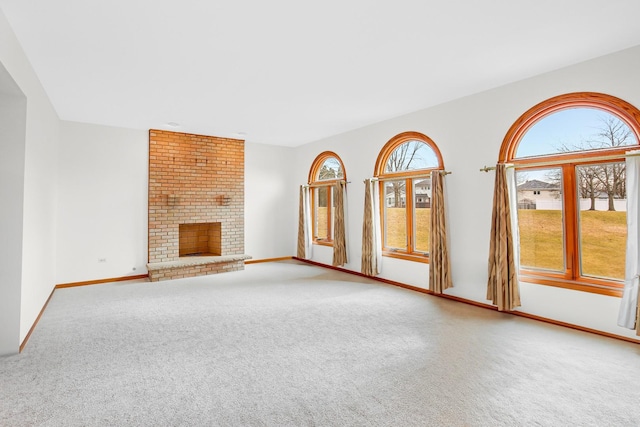 unfurnished living room featuring a fireplace and carpet