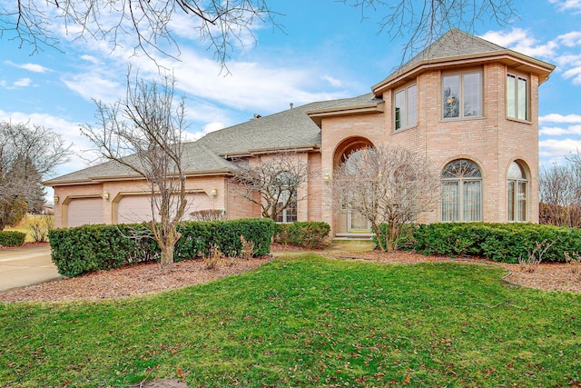 view of front facade featuring a garage and a front lawn