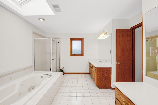 bathroom featuring tile patterned floors, shower with separate bathtub, a skylight, and vanity