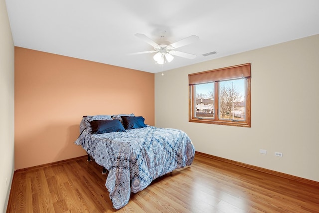 bedroom with ceiling fan and light wood-type flooring