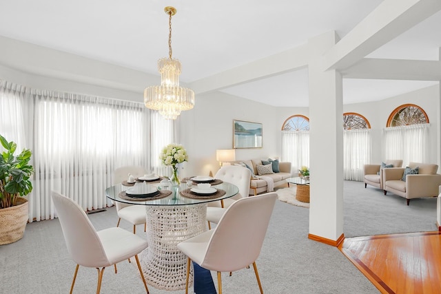 dining area featuring an inviting chandelier and light hardwood / wood-style floors