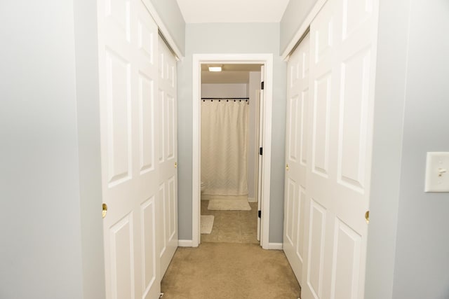 hallway featuring light carpet