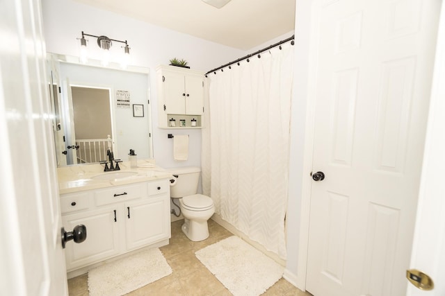 bathroom with vanity, tile patterned floors, and toilet