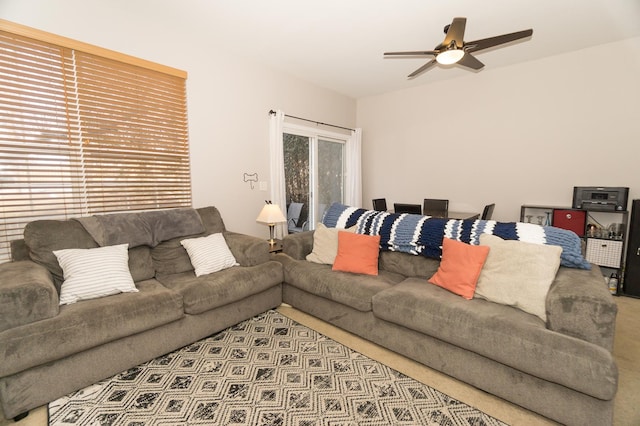 carpeted living room with ceiling fan