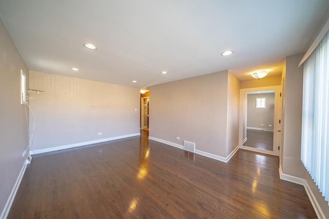 unfurnished room with dark hardwood / wood-style flooring