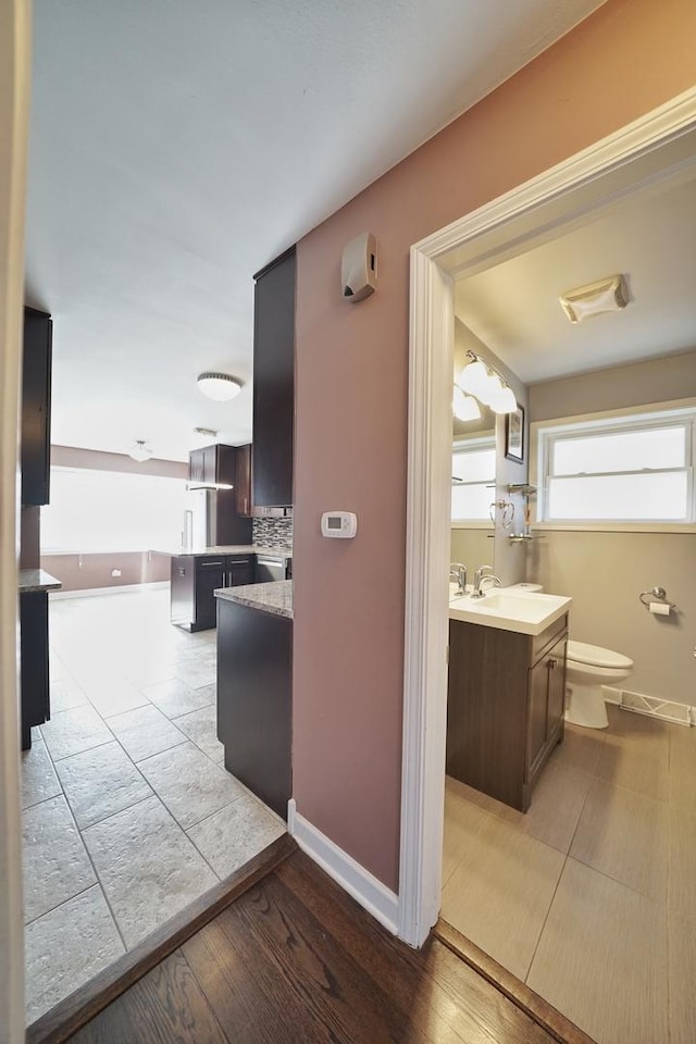 corridor featuring light hardwood / wood-style floors and sink