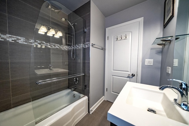 bathroom featuring tiled shower / bath and vanity