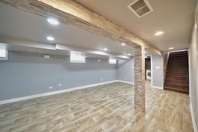 basement featuring washer / clothes dryer and light wood-type flooring