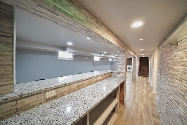 interior space featuring light stone countertops and light wood-type flooring