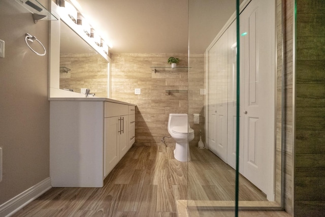 bathroom featuring hardwood / wood-style flooring, vanity, and toilet