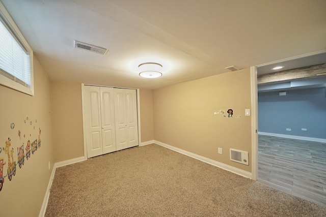 unfurnished bedroom featuring carpet and a closet