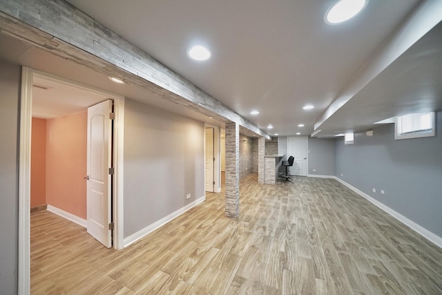 basement with light hardwood / wood-style flooring