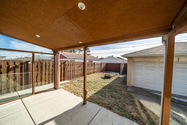 view of patio / terrace with a garage and an outdoor fire pit