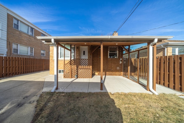 back of property featuring a patio and a lawn