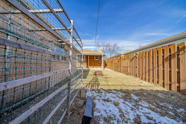 yard layered in snow featuring an outdoor structure