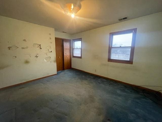 carpeted spare room featuring a healthy amount of sunlight