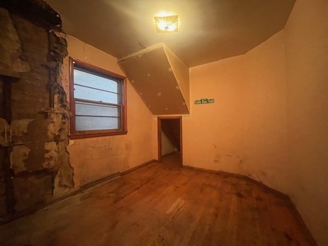 bonus room featuring vaulted ceiling and hardwood / wood-style floors