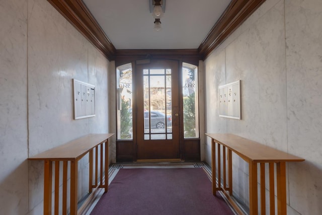 foyer entrance featuring crown molding, dark carpet, and mail boxes