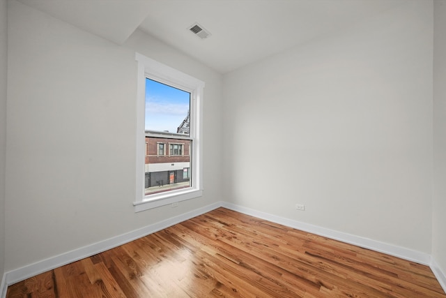 spare room with hardwood / wood-style flooring