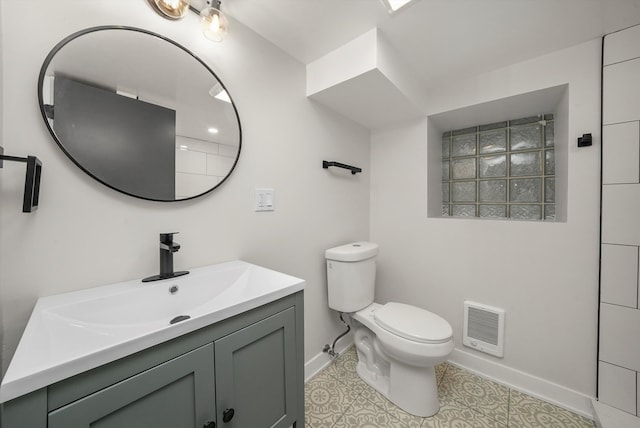 bathroom with vanity, toilet, and tile patterned flooring