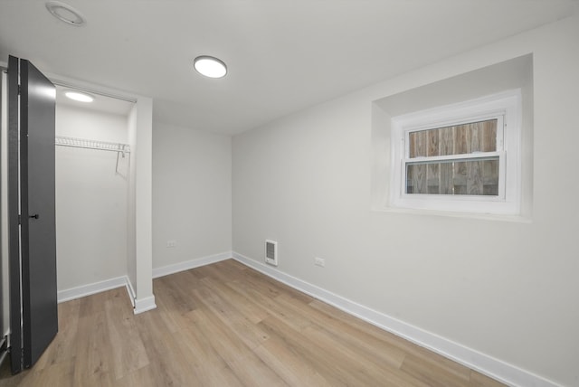 unfurnished bedroom with a closet and light wood-type flooring