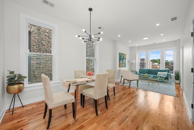 dining area featuring a chandelier and light hardwood / wood-style floors