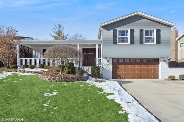 view of front of home with a garage and a front lawn