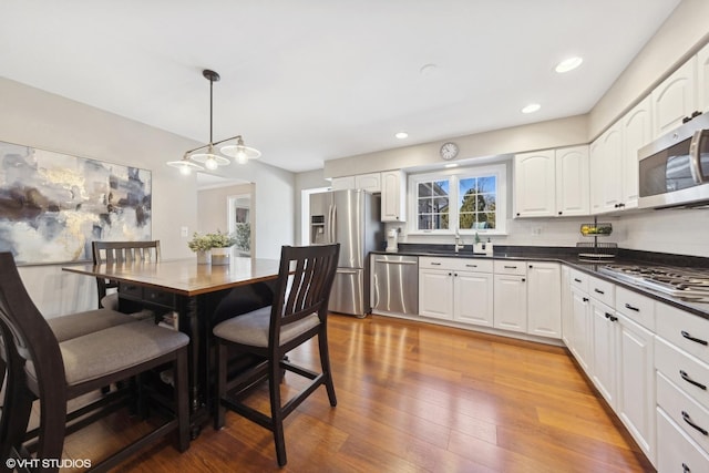 dining room featuring sink and light hardwood / wood-style floors