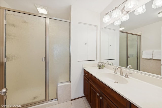 bathroom featuring an enclosed shower, vanity, and tile patterned floors