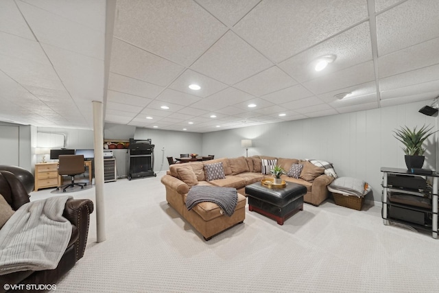 living room featuring a paneled ceiling and carpet