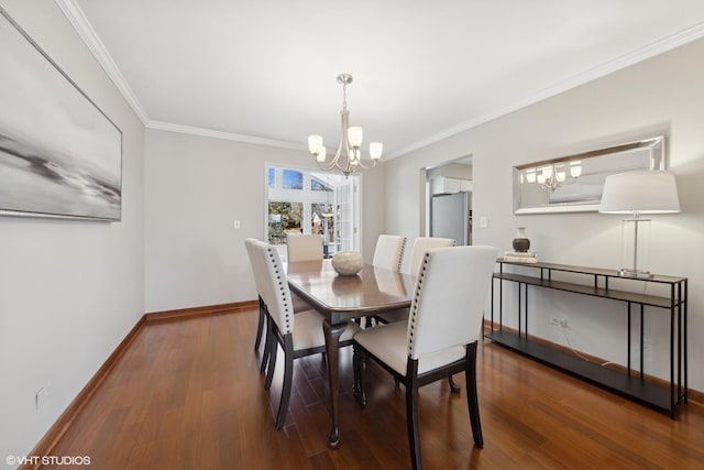 dining area with crown molding, dark wood-type flooring, and a notable chandelier