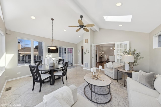 living room with lofted ceiling with skylight and ceiling fan