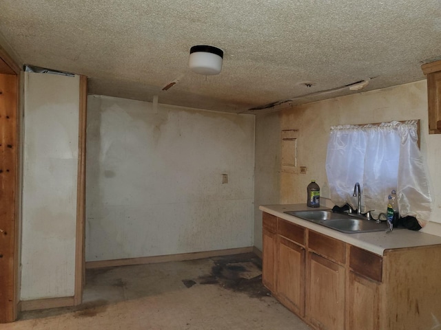 kitchen featuring sink and a textured ceiling