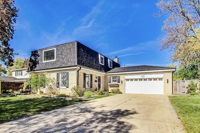 view of front of home featuring a garage and a front yard